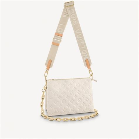 cream colored louis vuitton bag.